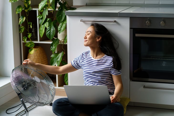 Woman working in front of a fan