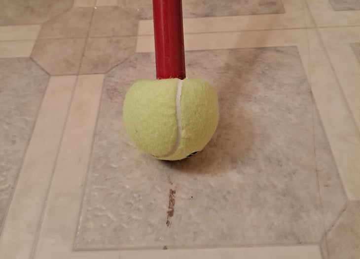 Tennis ball used as a scuff mark remover