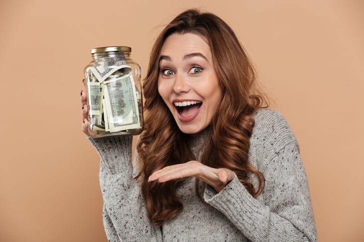 woman with jar of money