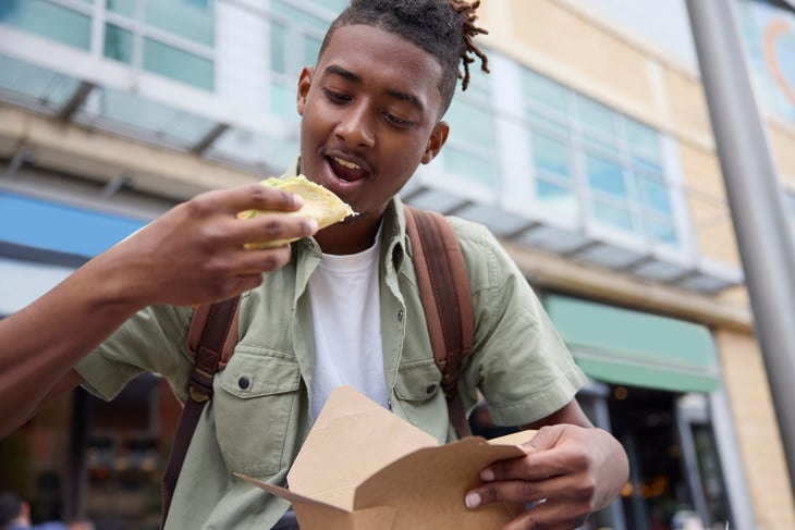 Young man eating a taco