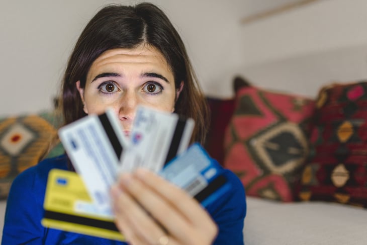 Worried woman holding credit cards