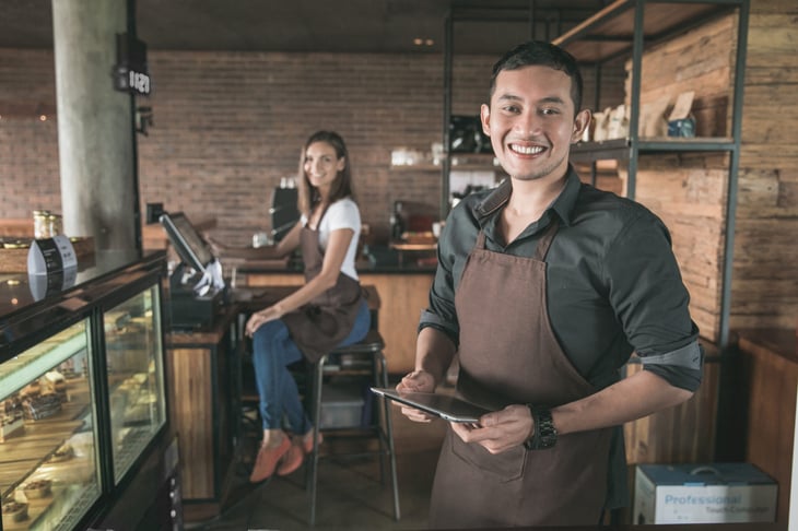 Cafe owner and worker at work
