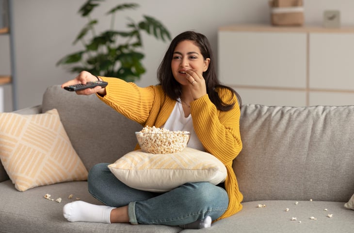Happy woman watching TV