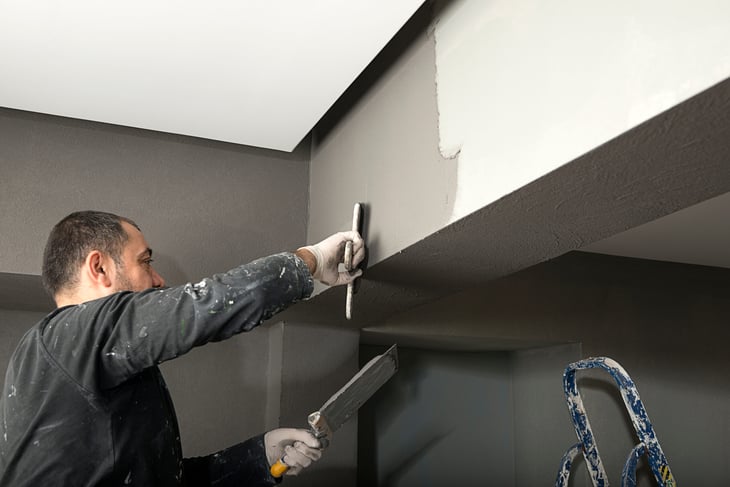 Man painting a room midtone pewter gray