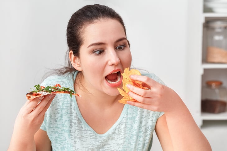 Woman binging on food