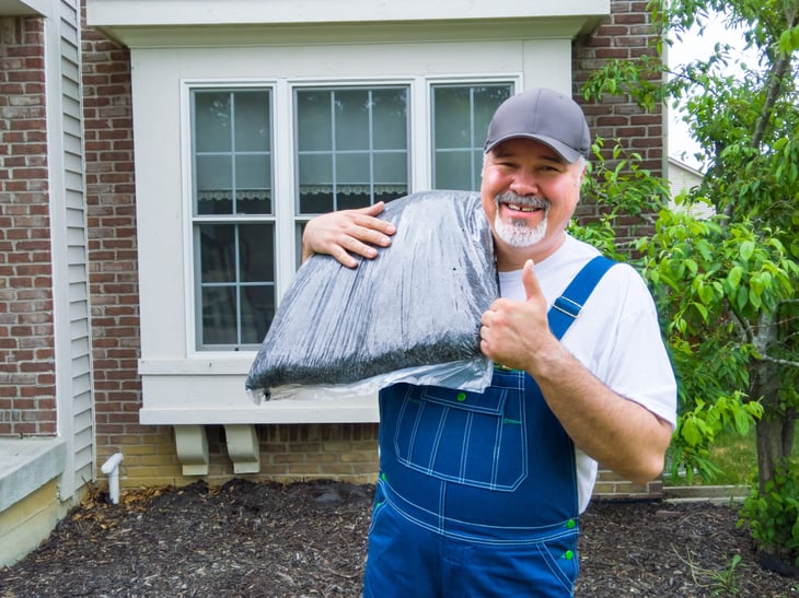 happy man with bag of mulch