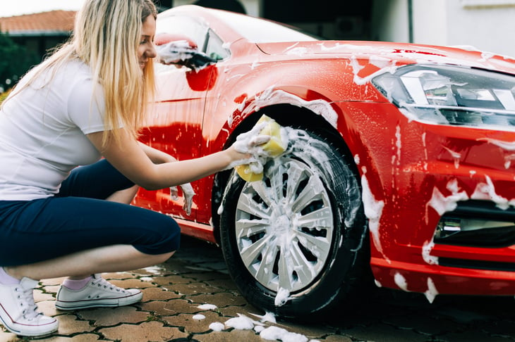 Woman washing car tires