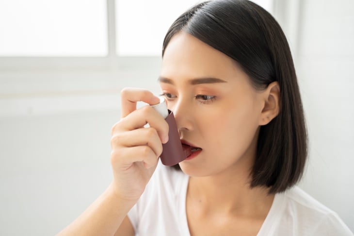 Woman using an inhaler