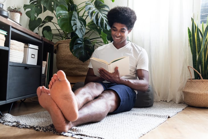 Man reading a book at home