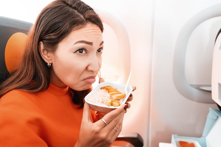 Woman eating smelly food on an airplane flight