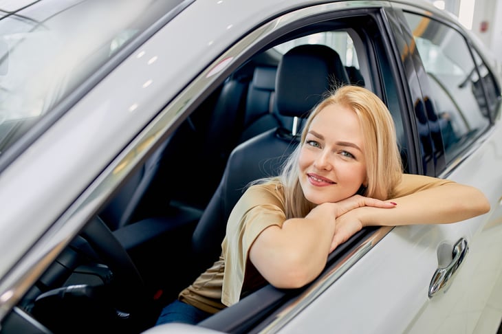 woman sitting in new car