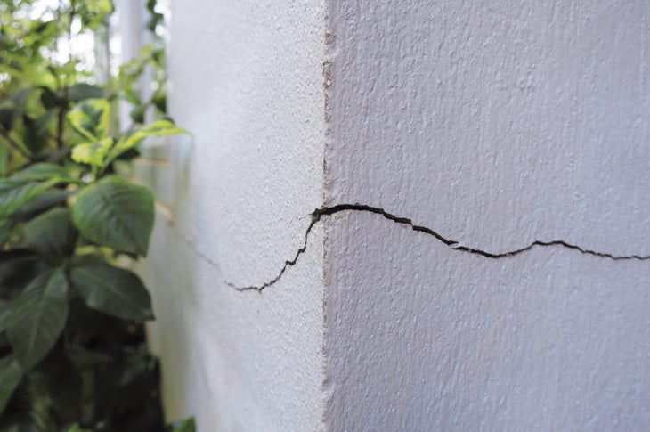 Cracked wall outside house, unsafe structure