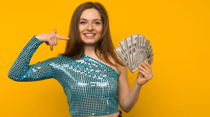 Happy smiling woman with lots of money