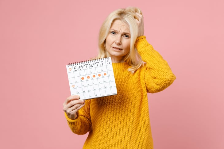 Upset woman holding a calendar