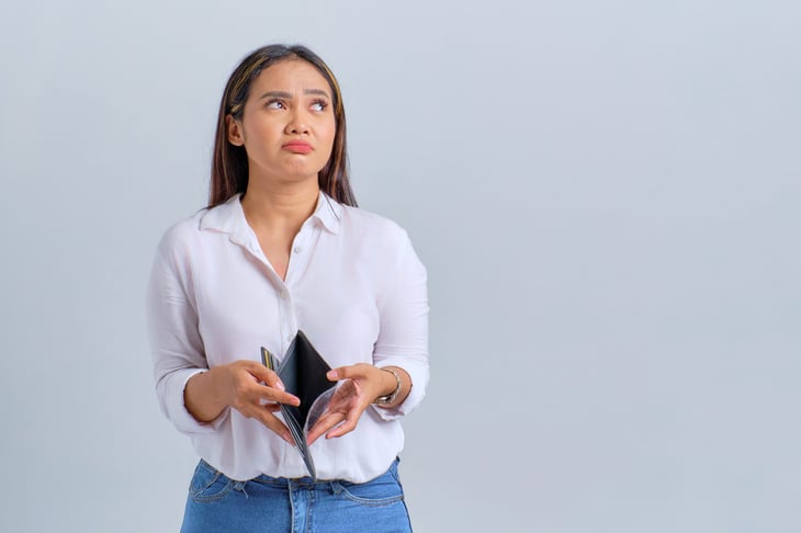 Unhappy woman with empty wallet