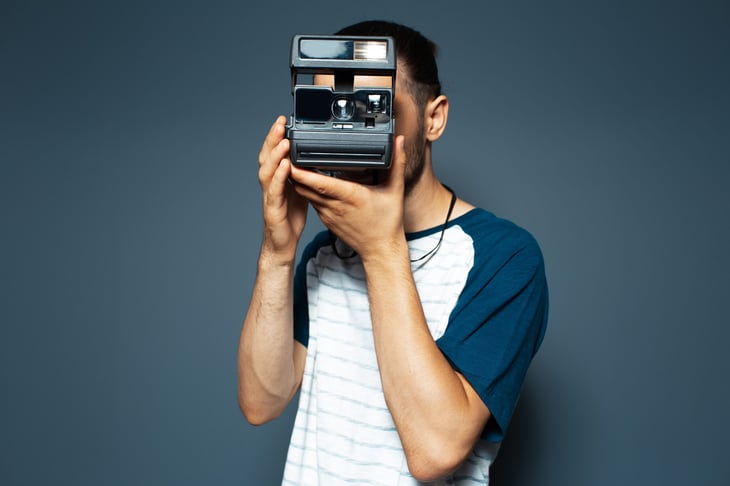 Photographer using a Polaroid camera