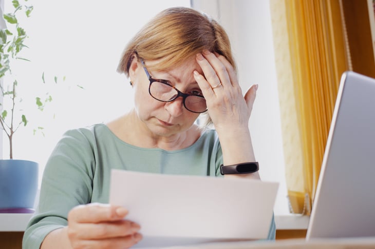 Upset woman worrying about a document