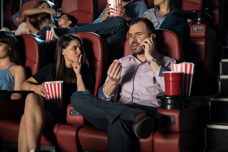 rude man on cell phone during movie