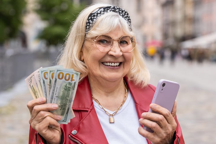 Senior woman holding cash