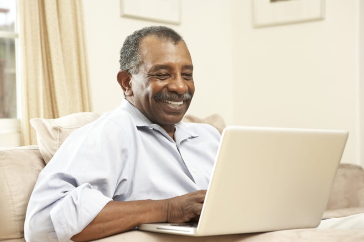 Happy pensioner on a laptop