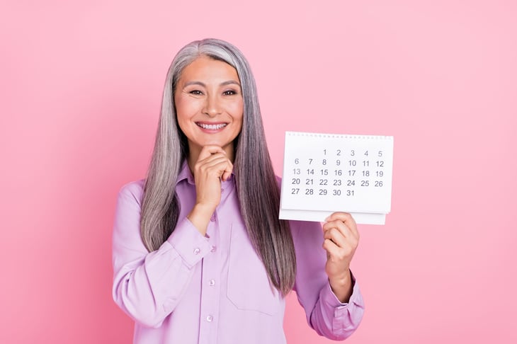 Happy older woman with calendar