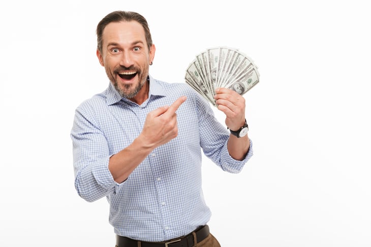 Excited man holding money
