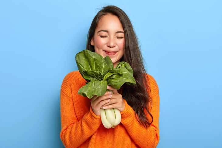 woman happy with green leafy vegetables