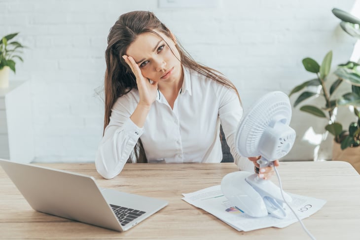Upset woman with a fan
