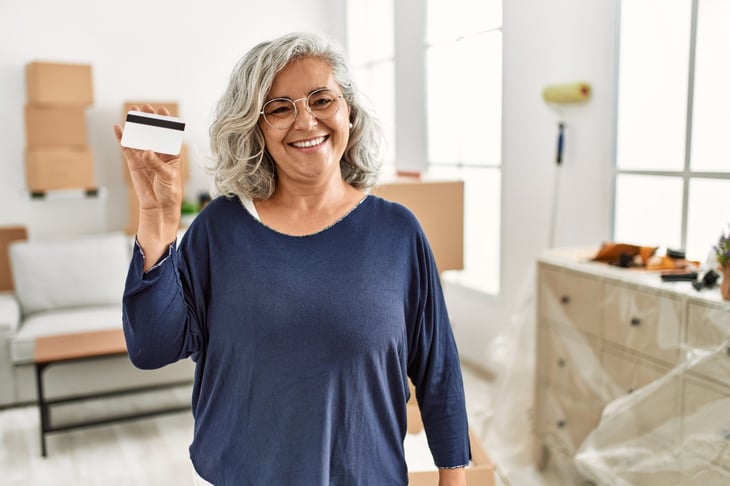 Happy older woman relieved she can manage her credit card debt