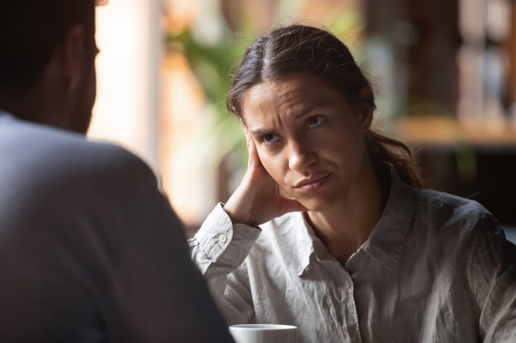Stressed woman discussing financial fears over coffee