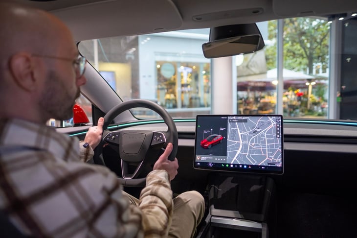 man test driving a Tesla