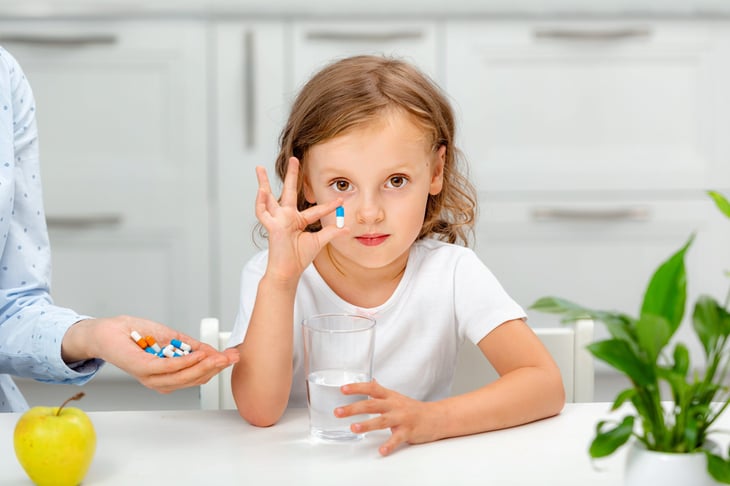 Little girl taking medication