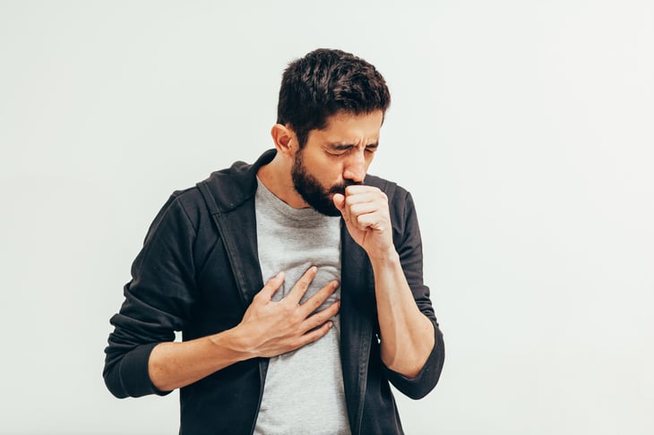 Coughing man who is sick and not breathing well