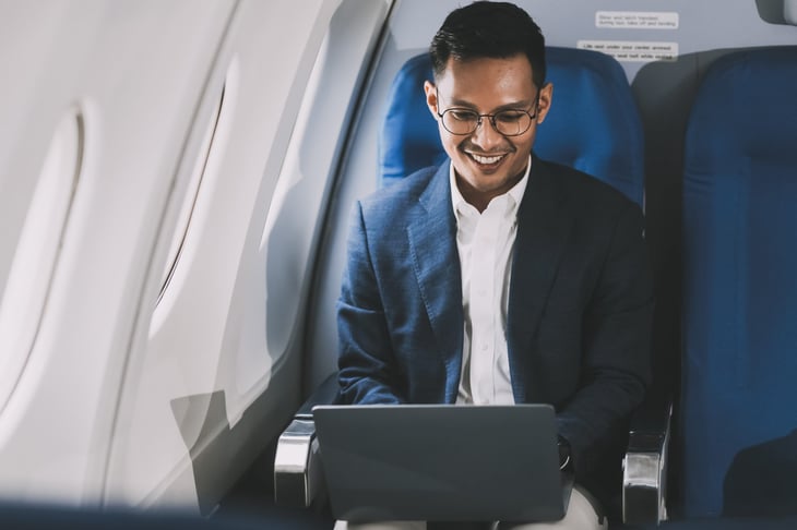 Man on a laptop in an airplane