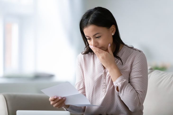 A woman reading a letter from the IRS