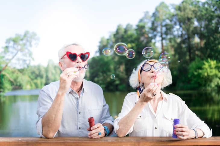 Senior couple blowing bubbles
