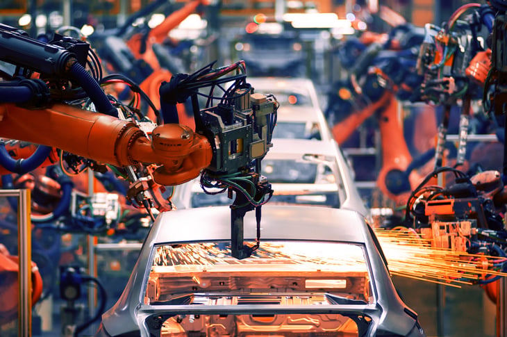 Robotic arms working on an automotive assembly line