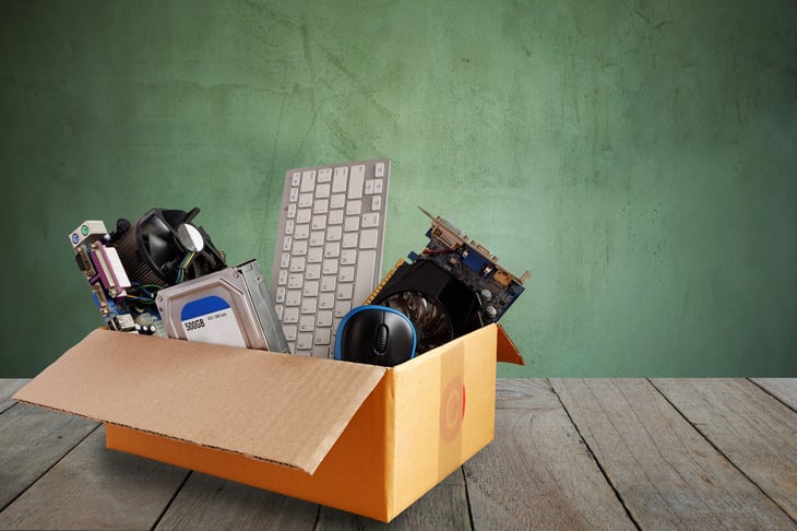 Donation box filled with old office equipment and electronics