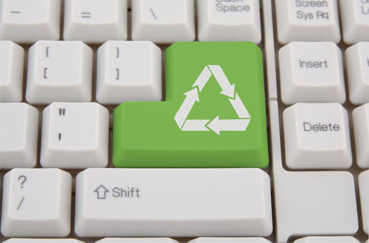 Computer keyboard with green Enter key with recycling symbol