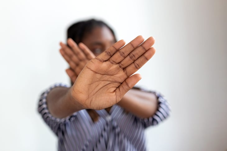 Woman holding up hands to stop