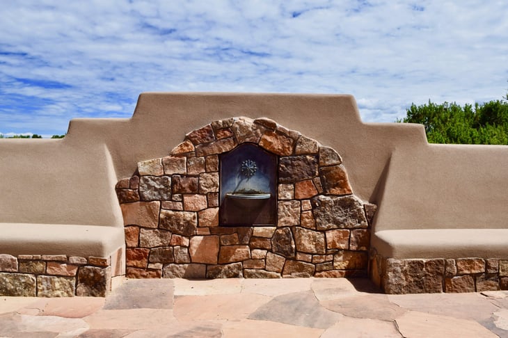 Outdoor fireplace with stucco and decorative stone