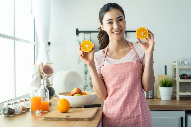 Woman holding a sliced orange