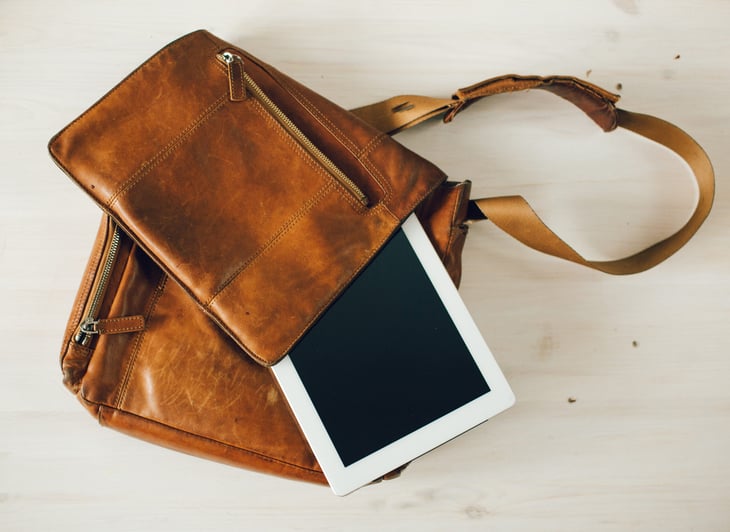 A tablet in a vintage leather bag