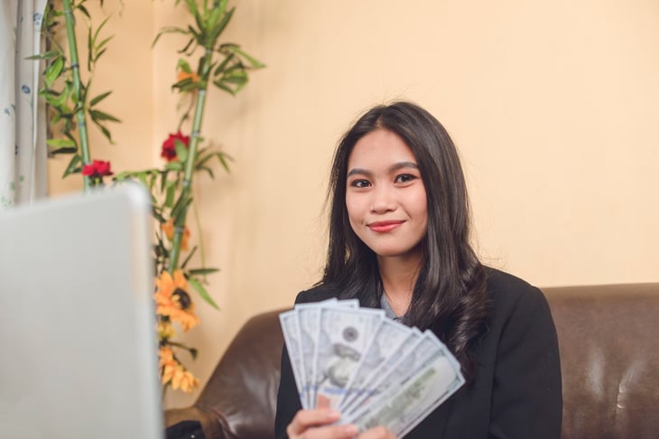 Woman from Generation Z holding cash