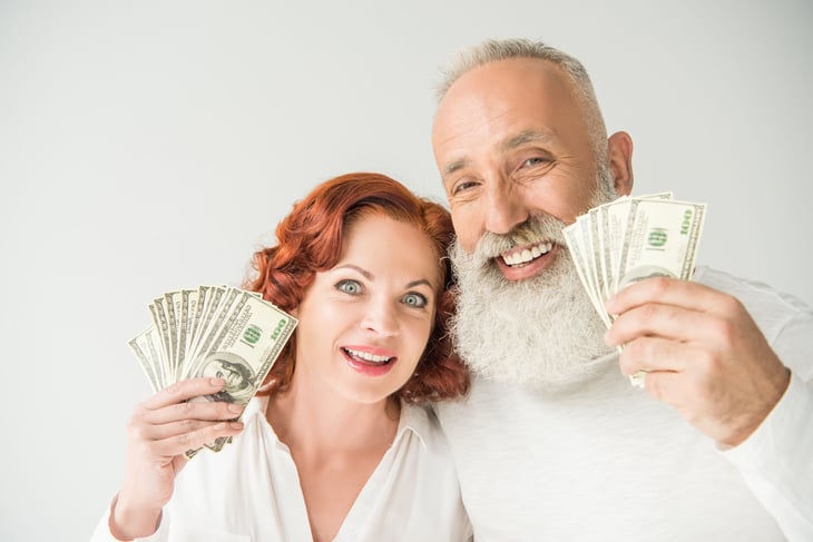 Senior couple with cash