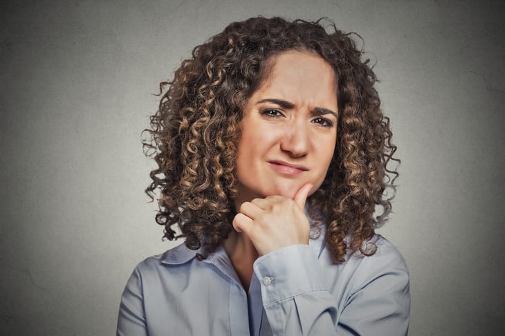 Skeptical or judgmental woman looking confused or doubtful