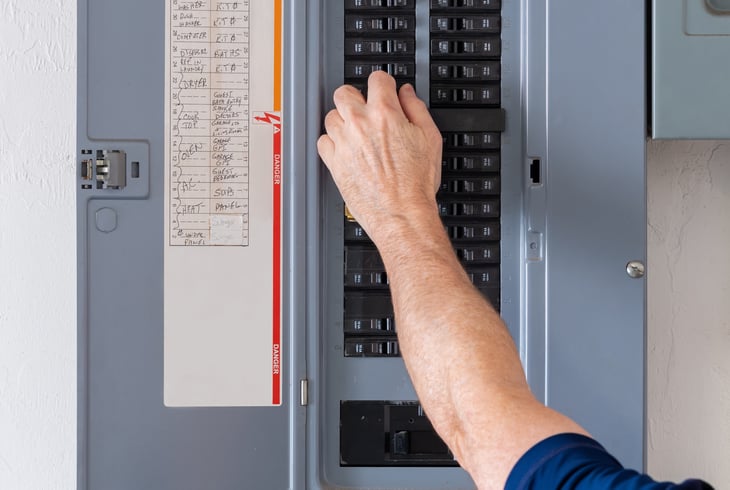 Electrician turns off the electricity at the fuse box.