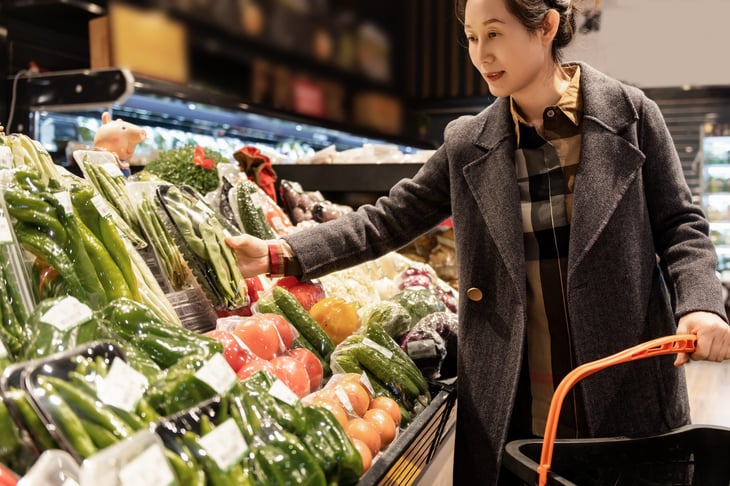 Shopper in the produce section of a grocery store