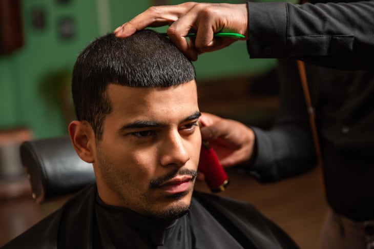 A man gets a haircut at a barber shop