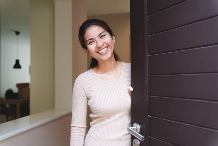 Woman opening her front door